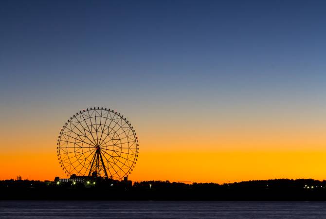 A sunset behind a ferris wheel