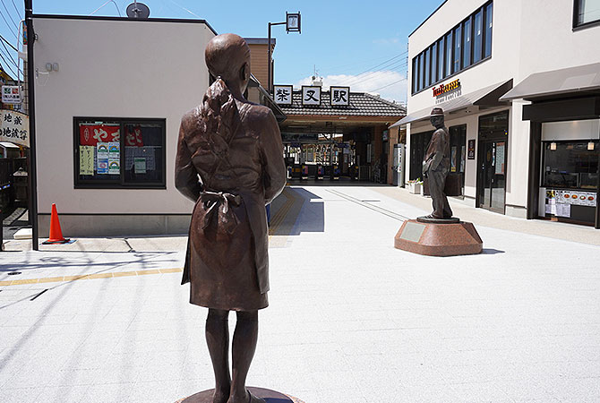 A bronze statue in front of the station